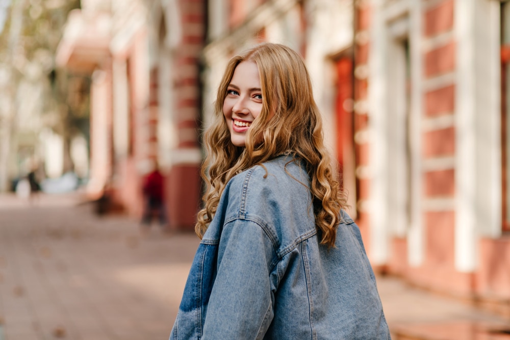 Portrait,Of,A,Blonde,Curly,Haired,Woman,Walking,On,The general dentist boston