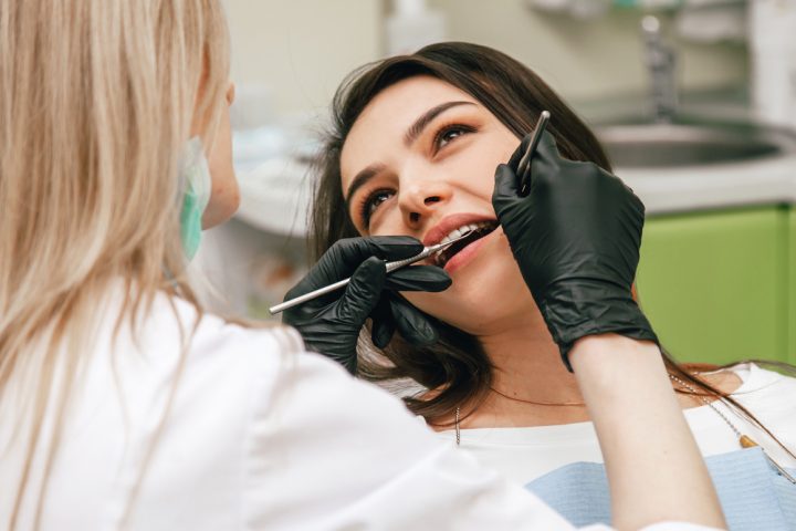Dentist,Examines,Teeth,Of,A,Client,In,A,Green,Office Root Canal Therapy in Chelsea